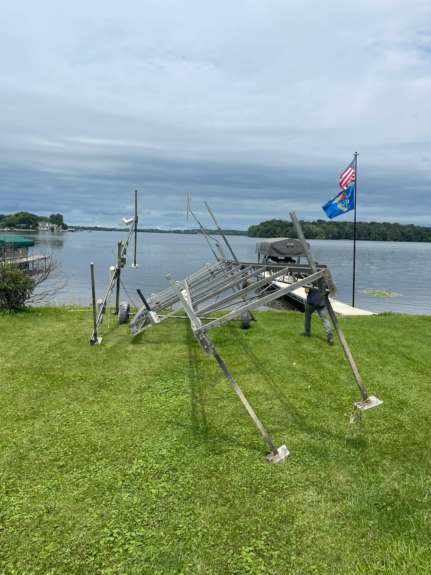 Damaged boat lift frame collapsed on the shoreline before repair