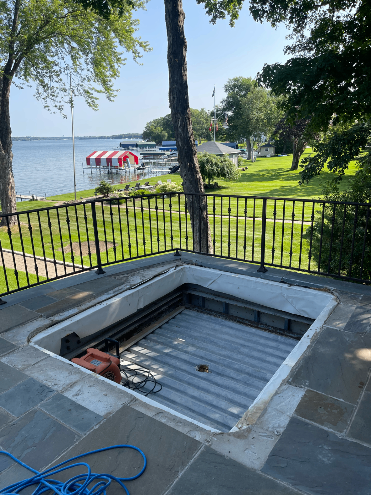 Lakefront patio deck opened up exposing steel deck pan and framing